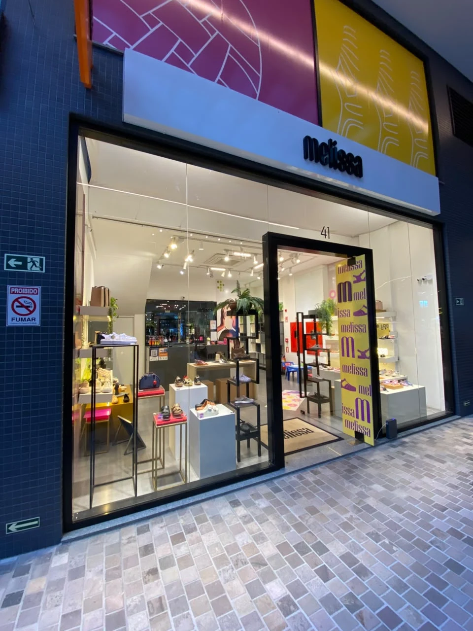 Storefront with the Melissa logo, footwear display and shop entrance